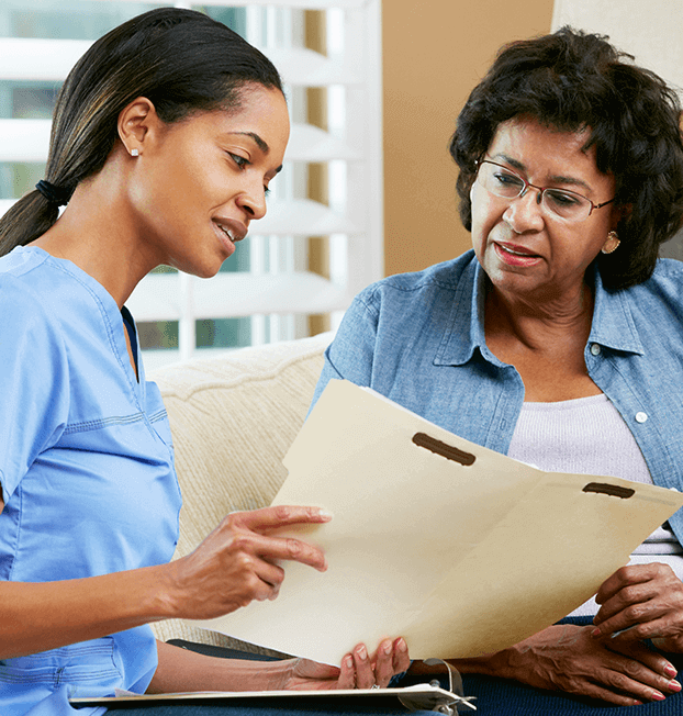 Young nurse going over charts with older woman